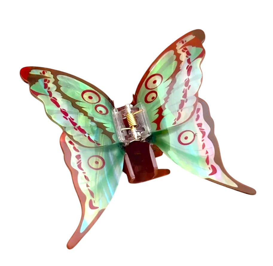 Butterfly-shaped hair clip with colourful wings on a white background